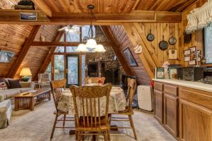 a dining room and living room of a cabin at Mountain Springs Chalet in Gatlinburg