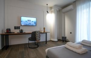 a room with two beds and a desk with a computer at CASA DIVINUS SUITES in Athens