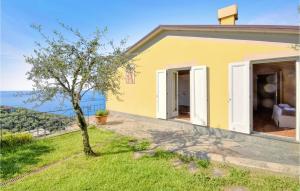 a small yellow house with a tree in front of it at S Rocco Dimora Tra Ulivi E M in Zoagli