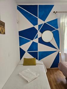a bedroom with a blue and white wall at Residence Pé na Areia in Albufeira