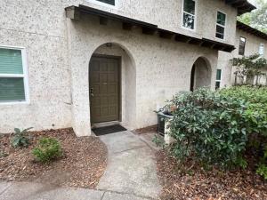 a house with a brown door in front of it at Tranquility in paradise- 2 bedroom villa w/parking in Hilton Head Island