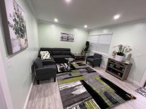 a living room with a couch and chairs and a table at Tranquility in paradise- 2 bedroom villa w/parking in Hilton Head Island