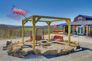 a playground with a bench and a swing at Scenic Ranch House with Fishing Pond! 