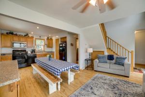 a living room with a table and a kitchen at Cottage in Edinboro Walk to Pat Crawford Beach! in Edinboro