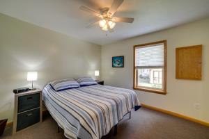 a bedroom with a bed and a ceiling fan at Cottage in Edinboro Walk to Pat Crawford Beach! in Edinboro