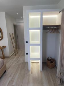 a room with a closet with white shelves in it at Olea White in Skiathos Town