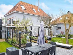 a patio with a table and an umbrella at 6 person holiday home in Otterup-By Traum in Otterup