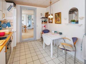 a kitchen with a white table and chairs in a room at 6 person holiday home in Otterup-By Traum in Otterup