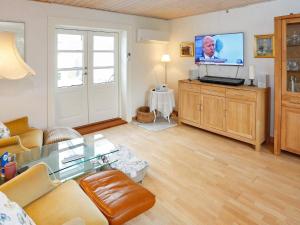 a living room with a couch and a flat screen tv at 6 person holiday home in Otterup-By Traum in Otterup