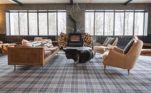 a large living room with couches and a fireplace at Hunter Lodge, a Bluebird by Lark in Hunter
