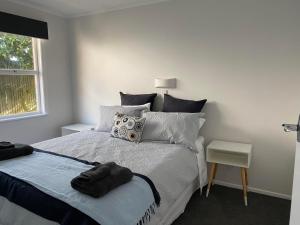 a bedroom with a bed with two towels on it at Lovely Newly Renovated Home in Hamilton