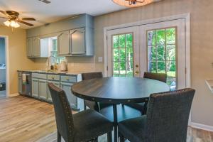 a kitchen with a dining room table and chairs at Cozy High Point Vacation Rental Near HPU Campus in High Point