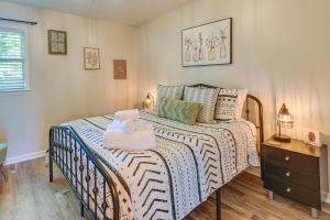 a bedroom with a bed with two towels on it at Cozy High Point Vacation Rental Near HPU Campus in High Point