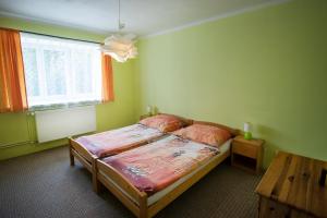 a bedroom with a bed and a window and a table at Ubytování u Nováků in Malá Morávka
