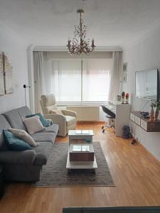 uma sala de estar com um sofá e uma mesa em Confortable y luminoso apartamento em Valladolid