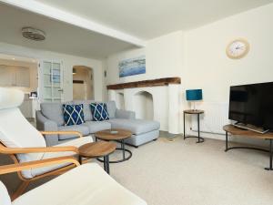 a living room with a couch and a tv at Ferry View in Dartmouth