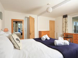 a bedroom with a large white bed with towels on it at Ferry View in Dartmouth