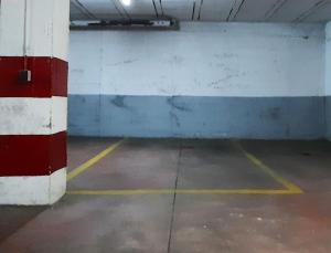 an empty parking garage with red white and blue at Sevilla Suite Torre Triana, parking free gratis! in Seville