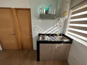 a small kitchen with a sink and a counter at TinyApartments - estudio pleno centro Concepción in Concepción