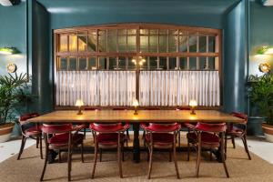 a dining room with a table and chairs at Palihotel San Diego Gaslamp Quarter in San Diego
