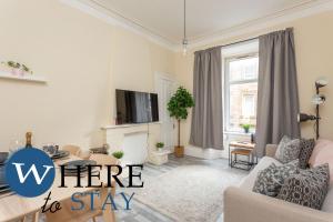 a living room with a couch and a tv at Brunswick road Lovely 2 Bed Apartment in Edinburgh