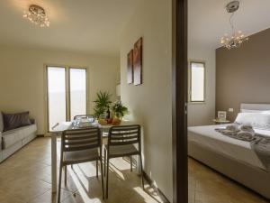 a bedroom with a table and chairs and a bed at Gloria del Mare - swimming pool with nice sea view in Civezza