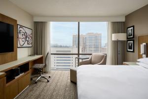 a hotel room with a bed and a large window at Houston Marriott Medical Center/Museum District in Houston