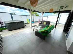 a living room with a couch and a table at Les cocotiers d'Aladya in Lamentin