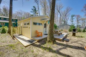 a yellow tiny house with a picnic table and a tree at 4-Season Gold Coast Cottage, 2 Mi to Winter Sports in Muskegon