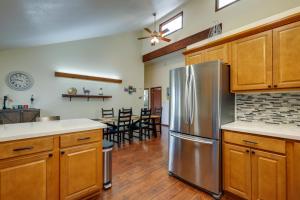 a kitchen with wooden cabinets and a stainless steel refrigerator at Scenic Flagstaff Home with EV Charger, 10 Mi to Dtwn in Flagstaff
