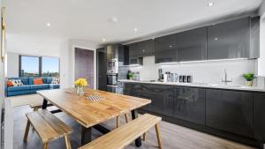 cocina y comedor con mesa de madera en Host & Stay - The Baltic Penthouse 2, en Liverpool