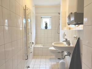 a bathroom with a sink and a toilet and a tub at 3 Betten Unterkunft Vahrenwald-List in Hannover