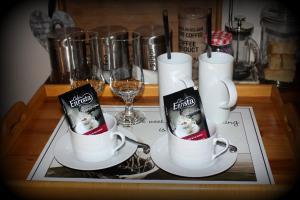 a table with two coffee cups with a book on them at Olive Tree B&B in Upington