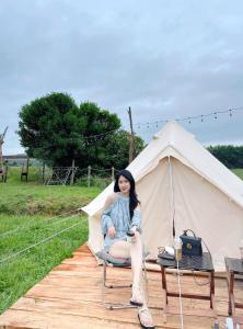 峰牙的住宿－Lèn Chùa Ecostay，坐在帐篷里椅子上的女人