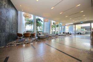 a lobby with chairs and tables in a building at BB on the Park 504 in Gold Coast
