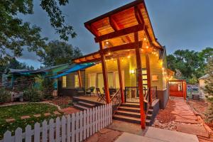 uma pequena casa amarela com uma cerca branca em Fort Collins Vacation Rental with Private Hot Tub! em Fort Collins
