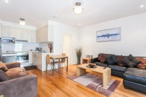 a living room with a couch and a table at Anglesea River Apartment 23 in Anglesea