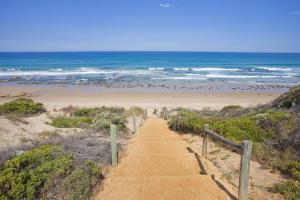 a path leading down to a beach with the ocean at Anglesea River Apartment 23 in Anglesea