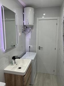 a white bathroom with a sink and a shower at CASA PARAISO 3 in Corralejo