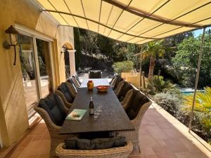 a patio with a table and chairs on a patio at Opulent Villa in Le muy with Swimming Pool in Le Muy