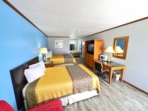 Sweet SpringsにあるNight Innのベッド2台とデスクが備わるホテルルームです。