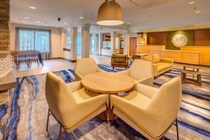 a hotel lobby with a table and chairs at Fairfield by Marriott at Lakewood Ranch - Sarasota in Sarasota