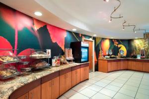 a restaurant kitchen with a counter with food on it at Fairfield Inn & Suites by Marriott State College in State College
