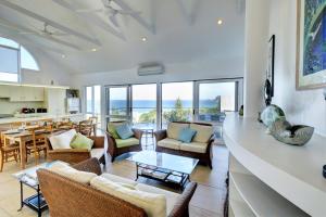 an open living room with a view of the ocean at Eureka in Boomerang Beach