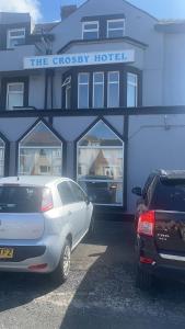 two cars parked in front of a cheney hotel at Crosby Hotel in Blackpool