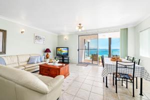 a living room with a couch and a table at Bayview Towers in Nelson Bay