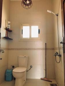 a bathroom with a toilet and a window at Luna House Lighthouse in Dahab