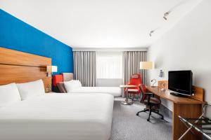 a hotel room with two beds and a desk at Holiday Inn Express Braintree, an IHG Hotel in Braintree