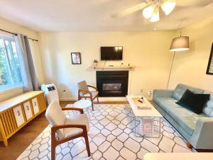 a living room with a couch and a fireplace at The Finch Beach Resort in North Bay