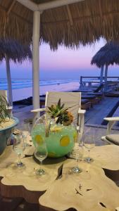 a table with wine glasses on a beach at AZVLIK in Rivas